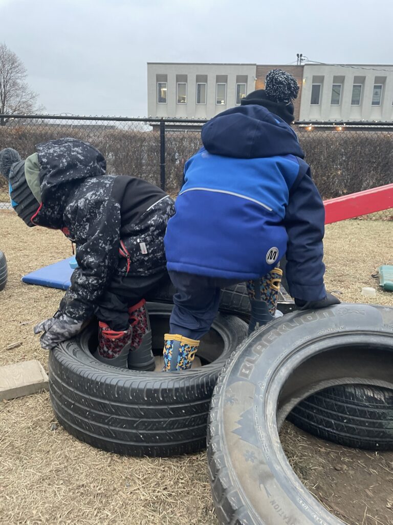 Wyatt and Kurt climbing and sitting on their “fort”